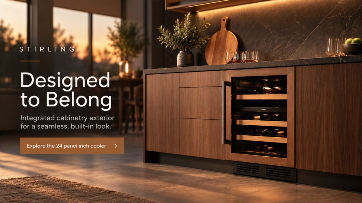 Campaign hero image: a walnut kitchen run at golden hour with an integrated panel-ready beverage cooler, headlined “Designed to Belong” over a button reading “Explore the 24 panel inch cooler”.